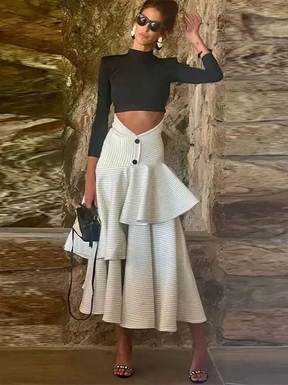 Fashionable high necked long sleeved top with ruffled edges and layered high waisted long skirt set